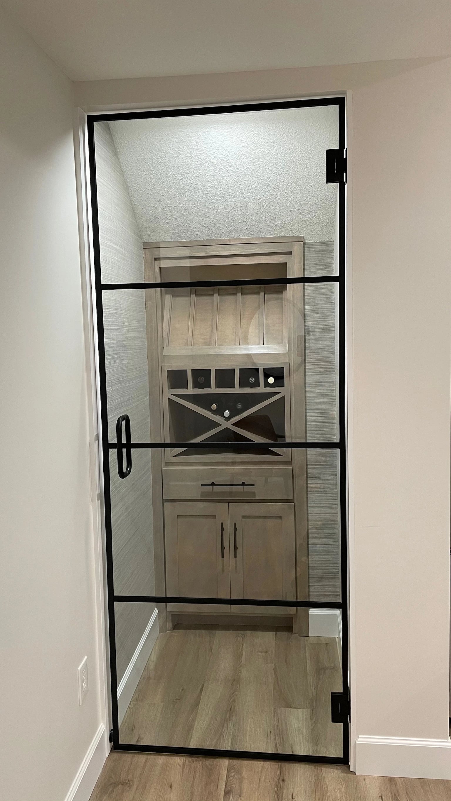 Open custom glass door to wine nook