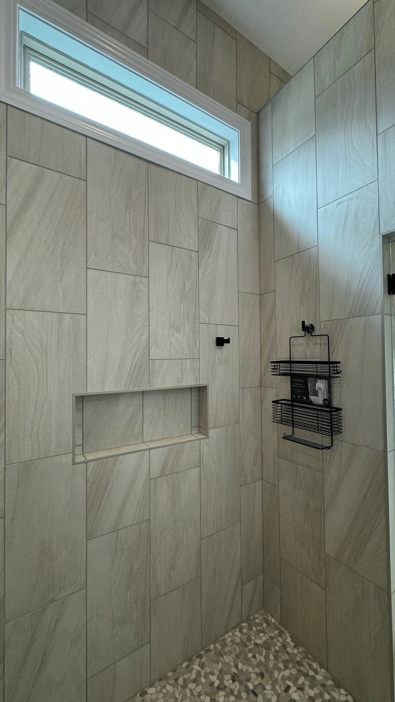 Tall shower tile, niche and high window